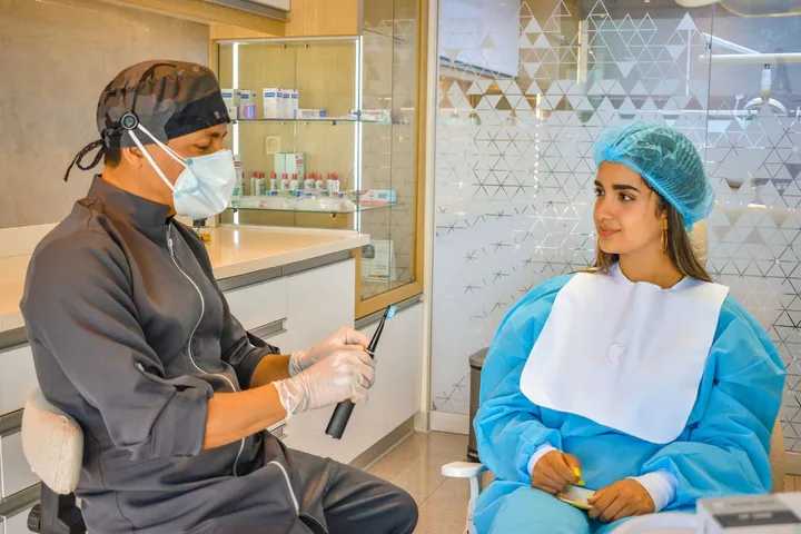 A dentist consulting with a patient about full-arch All-on-6 dental implant treatment